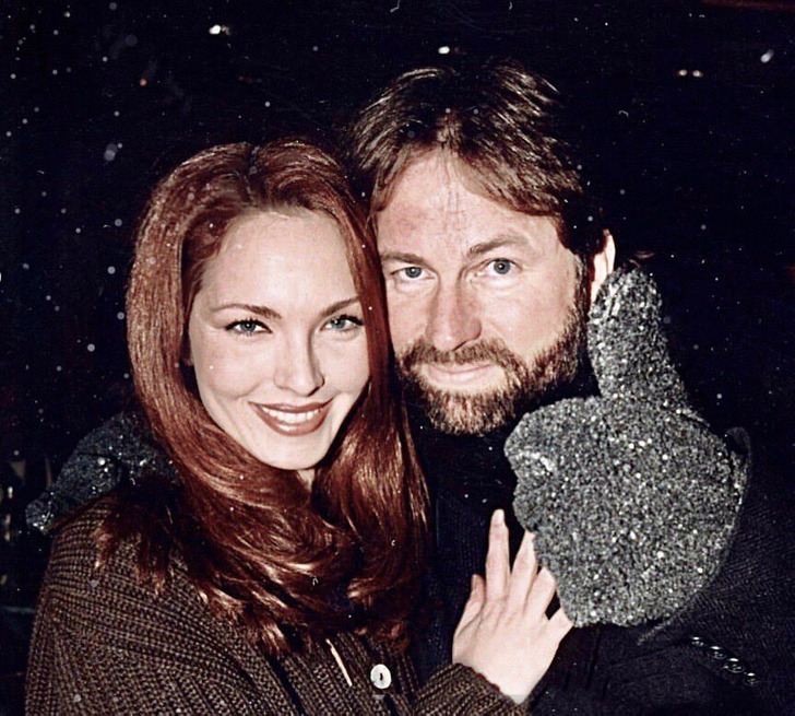 John Ritter with his wife in woolen clothes at night while it snows.